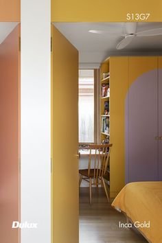 a bedroom with yellow walls and purple cabinets