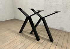 a black table sitting on top of a wooden floor