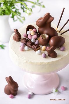 a cake decorated with chocolate bunny candies and marshmallows