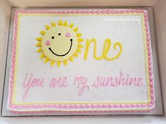 a cake decorated with the words one you are my sunshine and a smiling sun on it