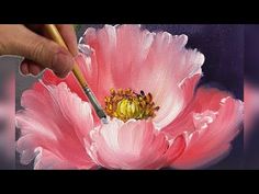 someone is painting a pink flower with a brush