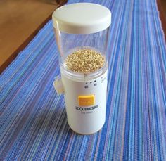 a blender filled with cereal on top of a blue tableclothed place mat