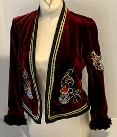 this Up - Cycled Mod Style Velvet Jacket is made from Burgundy Velvet.   The embroidery is gold burgundy and silver in an elven motif.   Very cool looking jacket with jeans or dresses, it can be dressed up or down, go boho or fancy! The embroidery is stitched on the front, back and one sleeve.   The sleeves are embellished with a black chiffon floral trim. The neckline and hem are trimmed in black and gold.  The sleeves are 3/4.  This is an old Navy size XS blazer style jacket .  It measures 34 in the bust and is 18.5 inches long. Velvet Jackets, 1950 Style, Royalty Core, Jacket With Jeans, Embellished Blazer, 1950 Fashion, Mod Style, Burgundy Velvet, Mod Fashion