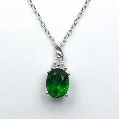 A fantastic jewelry piece to make your mother's neckline stylish.  In this gleaming Silver pendant, a brilliantly oval cut precious emerald birthstone, as shown, includes 3 round cut dazzling Cubic Zirconia. This luxurious glowing emerald centerpiece weighs 2.95 carats, measures 9x7 mm, and is an excellent prong set. Surely this elegant minimalist pendant will be a symbol of unconditional love. Birthstone Emerald Necklace Silver May birthstone jewelry Oval cut pendant Trendy Best Friend Gift Sentimental Promise Pendant casual, typical, simple, handmade pieces vintage, elegant design, Minimalistic Minimalist pendant chain Minimal Delicate cute jewelry pieces keychain pendant for her gift Necklace promise Pendant necklace for women very small classic pendant necklace unfussy jewelry design s Power Jewelry, Classic Pendant Necklace, Tiny Heart Necklace, Jewelry Promotion, Emerald Birthstone, Minimalist Pendant, Jewelry Board, Gemstone Pendants, Minimal Necklace