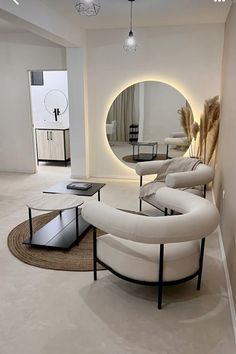 a living room filled with furniture and a round mirror