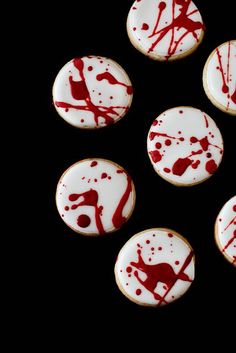 some cookies with red and white icing on them