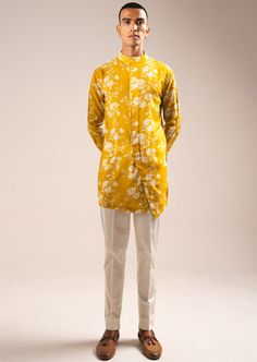 The yellow white rose side slit kurta set includes a yellow kurta with a cream pajama. The kurta is constructed with our signature, lightweight mallai cotton fabric. This is a two-piece cotton set. The kurta has a band collar, double placket detail that turns into an angular side slit, and concealed buttons. This kurta has cuffed sleeves and boasts an all-over floral print from our archives. The trouser-style pajama features an elasticated back, zip and fly front closure, and two hip pockets. Th Yellow Kurta, Rahul Khanna, Payal Singhal, Potli Bags, Kurta Pajama, Nehru Jackets, Western Wedding, Cotton Set, Trouser Style