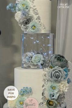 a three tiered wedding cake with blue flowers on the top and white frosting