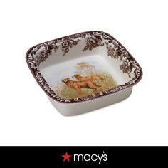 a brown and white dish with a dog on it's side, in the shape of a square bowl