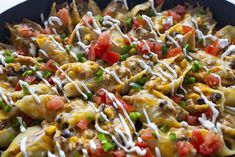 a skillet filled with tortilla shells covered in cheese and veggies