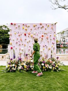 a person standing in front of a flower display