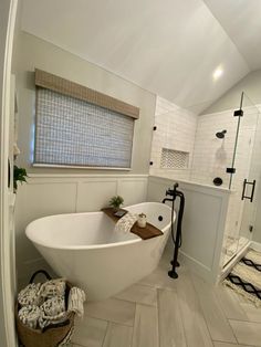 a large white bath tub sitting inside of a bathroom