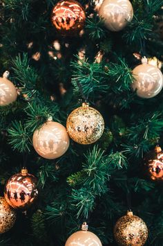 a christmas tree with gold and silver ornaments