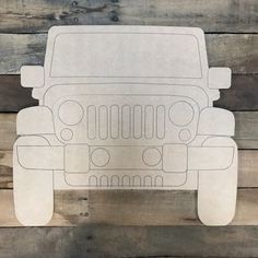 a paper cut out of a jeep on wooden planks