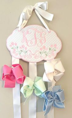 🎀🎀This is an adorable way to store and display your daughter's bows. It is a wonderful baby shower gift, birthday gift, or welcoming gift.  🎀This listing is for one bow holder. It is made with high quality swiss dot or pique bitty dot fabric. The back is covered so no embroidery will show through.  🎀 Approximate size is 9.50"x 6.50" Disclaimer: This is not a toy and is to be used for decoration purposes.  Returns: I do not accept returns due to the personalization of the product. Please mess Bow Organizer Nursery, Hair Bow Display, Hair Bow Ribbon, Bow Display, Ribbon Holders, Monogram Kids, Hair Bow Organizer, Bow Hanger, Bow Organizer