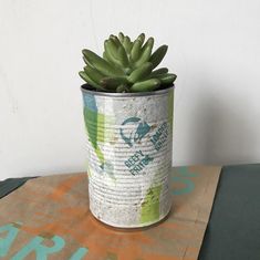 a plant in a tin can sitting on top of a table