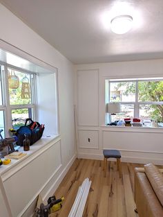 a room with hard wood flooring and windows in the wall next to each other