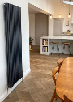 a kitchen with a large radiator next to a dining room table