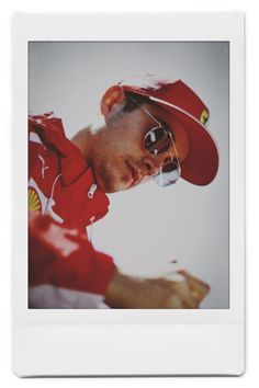 a polaroid photograph of a man wearing a red hat and sunglasses