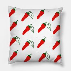 a red pepper pattern on a white pillow with green peppers in the middle and bottom