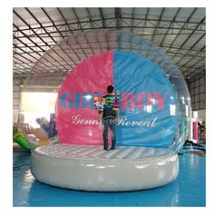 an inflatable ball with a man standing on it and the words give joy