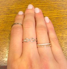 A delicate and beautiful sterling silver infinity ring on a scrolled band. Very feminine and delicate. This ring has a 11mm (.43 inches) face height and it is on a 2mm band. The perfect ring to wear with your other stackables! It also looks so pretty and dainty by itself. This ring would make a beautiful promise ring to show someone that your love for them is eternal. It would also make a wonderful alternate wedding band. We use the purest 925 sterling silver in all of our designs. We strive to Beautiful Promise Rings, Silver Infinity Ring, Infinity Ring, Infinity Symbol, Love Ring, Perfect Ring, Stackable Rings, Promise Ring, Stacking Rings