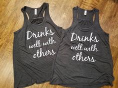 "Drinks Well With Others Tank Top//Flowy Drinking Tank//Womens Drinking Racerback Tank Top//Workout Tank Top//Summer Tank Top//Vacation Tank Welcome to Sheribottomline! This listing is for one Flowy Racerback Tank Top that says \"Drinks well with others\". Great tank tops for family vacation or for summer get togethers! These tank tops are SO cute, light and flowy! This is my new favorite style of tank. It is positively wonderful for those hot summer days! **Please note that the main picture is Cute Camping Outfits Summer, Cute Camping Outfits, Drinks Well With Others, Summer Camping Outfits, Camping Outfits For Women, Funny Drinking Shirts, Boat Shirts, Vacation Tops, 5 De Mayo