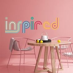 a table with chairs and a tea pot on it in front of a pink wall