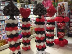 some balloons are arranged in the shape of hearts and stripes on display at a store