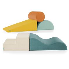 three pieces of furniture with different colors and shapes on top of each other, one in the shape of a wave