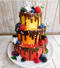 three tiered cake with fruit and chocolate icing