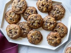 chocolate chip cookies are on a white plate