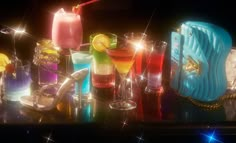 a table topped with lots of different types of cocktails and drinks on top of it