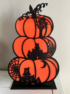 an orange and black pumpkin sculpture sitting on top of a table