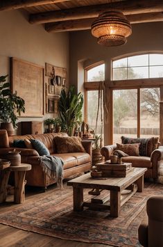 a living room filled with lots of furniture and large windows in the wall behind it