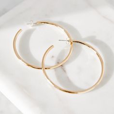 No woman’s wardrobe is complete without a quintessential pair of hoops. Made from 14k gold-plated brass, the Hayley Classic Hoops are an easy way to brighten up any outfit. The 2-inch width means these medium-sized hoops are ideal for day or night. Available in 14k gold plated brass Size: 2 inches Stainless steel post with friction back Made in the USA SKU: BYE1027 Chic Gold-tone Hoop Earrings For Everyday, Everyday Gold-tone Hoop Earrings, Tennis Jewelry, Steel Post, Athleisure Wear, Perfect Gift For Mom, Simple Earrings, Turquoise Jewelry, Birthstone Jewelry