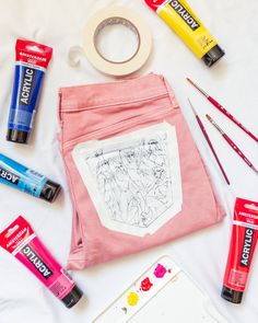 the contents of a craft kit laid out on top of a white sheet with crayons and markers