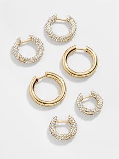 Three times the earrings, three times the layering. The Lucy Earring Set is complete with three pairs of huggie hoop earrings. Two pairs are encrusted with crystals, while the third is crafted in graphic gold. Wear a few together or break them apart for easy stacking every single day. Preppy Jewelry, 18k Gold Earrings, Jewelry Accessories Ideas, Crystal Hoop Earrings, Jewelry Lookbook, Earrings In Gold, Huggie Hoop Earrings, Girly Jewelry, Jewelry Inspo