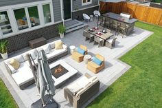 an aerial view of a patio with seating and fire pit in the back yard area