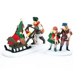 three figurines of people with a sleigh