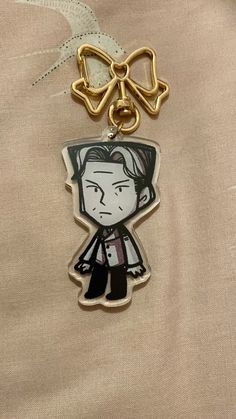 a keychain with an image of a person wearing a bow tie on it