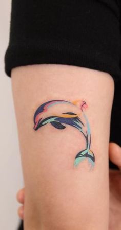 a small dolphin tattoo on the right thigh