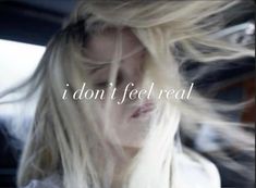 a woman with long blonde hair and the words, i don't feel real