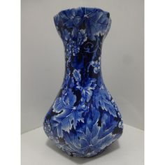 a blue and white vase sitting on top of a table