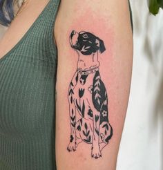 a black and white dog tattoo on the arm