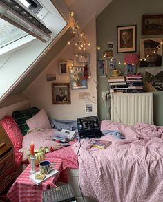 a bedroom with a laptop on the bed and many pictures hanging up in the wall