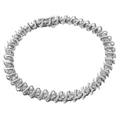 Classic and elegant, this beautiful silver bracelet is designed with an alternating pattern of "s" links and miracle set, natural diamonds. The silver is genuine .925 sterling silver, plated with rhodium (a platinum-family metal) for a lifetime of tarnish-free wear. The diamonds are round-cut and have a total carat weight of 1/4 cttw. The diamonds and silver work together to create a striking look, as this bracelet will shine bright on your wrist. This bracelet fastens securely with a box clasp. Family Metal, Bracelet Indian, Box Clasp, Diamond Settings, Silver Work, Bracelet Clasps, Diamond Color, Tennis Bracelet, White Diamonds