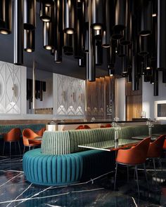 the interior of a modern restaurant with black and white marble flooring, blue velvet seating and chandeliers