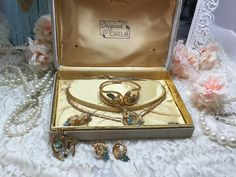 Beautiful complete vintage jewelry set. All gems are intack. Set includes necklace, spring action cuff bracelet, screw earrings, and two brooches. Box is marked Original by Carla. 1960s Jewelry Sets, Vintage Collectible Cuff Bracelet With Polished Finish, Vintage Cabochon Clip-on Earrings For Gift, Ornate Multi-stone Collectible Jewelry, Vintage Multicolor Clip-on Jewelry, Vintage Jewelry Sets, All Gems, Seed Pearl, Original Box