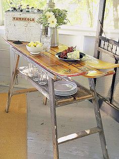 a wooden table topped with plates and bowls